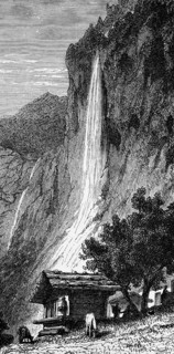 The Staubbach Falls near Lauterbrunnen in the Swiss Alps, wooden hut, steep slope, grazing cattle,