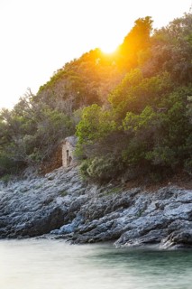 Crystal clear and turquoise water on the beach of Ustrine Bay on a sunny day at sunset on the