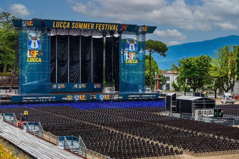Blue and black rows of chairs in the audience area, the large stage at the back, Summer Festival,