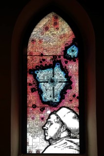 Colourful church window with portrait of Martin Luther, handicrafts, stained glass, interior view,