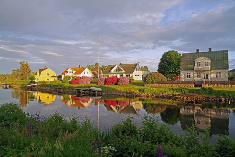 Picturesque house landscape reflected in the water, surrounded by blooming nature in spring, Göta