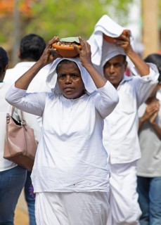 Sri Lankan pilgrims carrying offerings on their heads, Anuradhapura, North Central Province, Sri