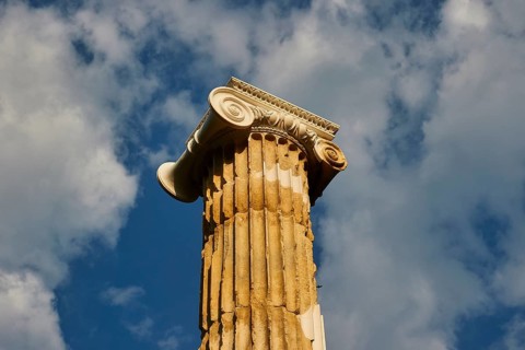 Pillar of Nike, Ancient Column with Decorated Capital against a Cloudy Sky, Archaeological Site,