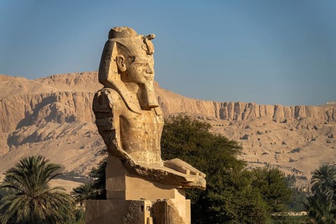 Statue in the ruins of the temple of Amenhotep III in the Nile Valley in West Thebes near Luxor,