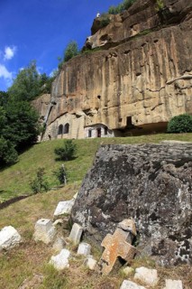 Corbii de Piatra rock monastery, stone ravens carved into a massive, 30-meter high sandstone wall,