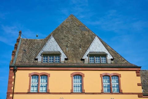 Traditional building with unusual gable roof under clear skies, Main,