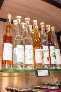 Various liquor bottles with labels on a wooden shelf, Café Kuh, Deckenpfronn, Germany