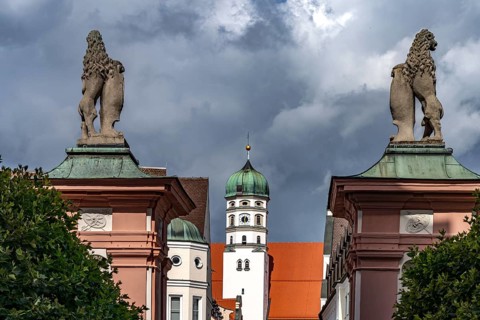 Lions guarding the castle and the tower of St Peter's Basilica in Dillingen an der Donau, Bavaria,