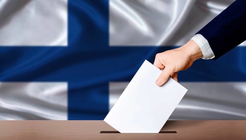 Finland Parliamentary vote 2026. Hand placing a ballot in ballot box with the Finnish flag in the