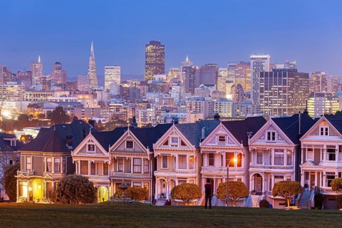 The Painted Ladies, Victorian wooden houses on Alamo Square and the San Francisco skyline at dusk,