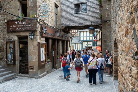 Mass tourism in the historic alleys of Rocky Island, Le Mont Saint Michel monastery island, tourist