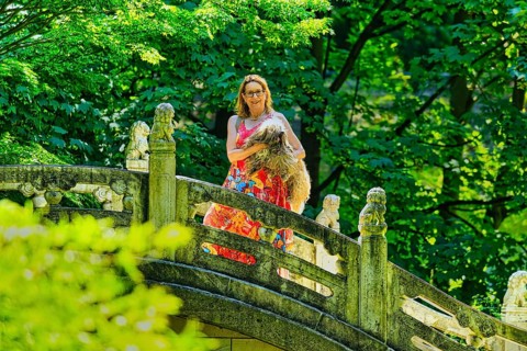 Woman with dog standing on a bridge, Chinese Garden at Duisburg Zoo, Duisburg, North