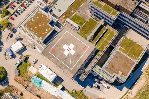 Complex urban building with helipad and green roofs from a bird's eye view, Nagold Hospital of the