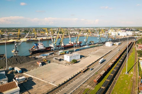 Poti, Georgia - 22nd august, 2025: aerial view Busy seaport with cranes, bulk piles, cargo ships,