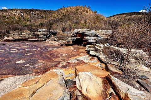 Impressive rock formations in a dry desert landscape under a clear blue sky, the thornshrub savanna