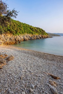 Crystal clear and turquoise water on the beach of Ustrine Bay on a sunny day at sunset on the