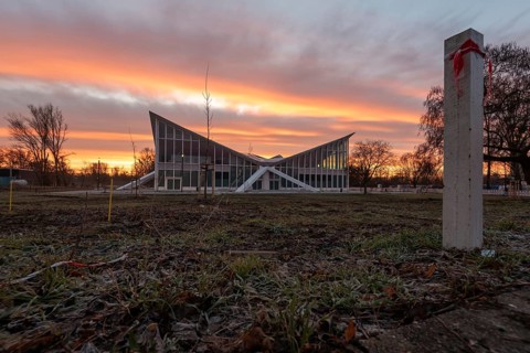 Hyparschale, heritage-protected building with striking roof construction in front of a dramatic