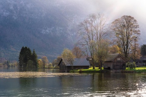 Lake Hallstatt near Steeg. Some boathouses. Autumn, backlight. Lake Hallstatt, Salzkammergut, Upper