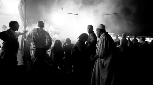 Night view of a busy food market, street market in black and white, full of people, evening food