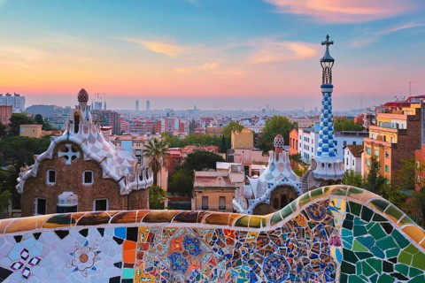 Barcelona city view from Guell Park with colorful mosaic buildings in tourist attraction Park Guell