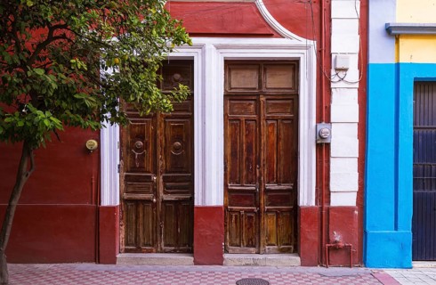 Brightly colored walls and traditional wooden doors in the historic center of Guadalajara, Mexico,