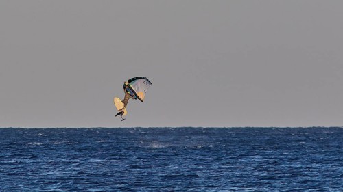 Wingfoiller, A kitesurfer in the air over the blue sea, Windsurfer, Meltemi windsurfing spot,