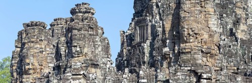 Panoramic image of giant stone-carved faces of the Bodhisattva Lokeshvara, also known as
