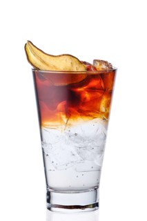 Espresso and tonic with pear syrup in highball glass isolated on white background