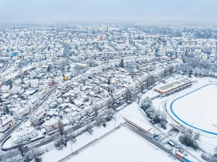 Sweeping aerial view of a snow-covered city with sporting detail, Sindelfingen, Germany