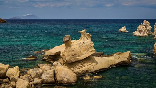 Natural coast with distinctive rock formations and turquoise blue sea, Aspragremna, White Cliffs,