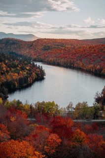 Stunning autumn foliage in Quebec showcases vibrant shades of orange, red, and yellow surrounding a