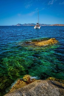 Yacht boat in Aegean sea at white rocks of Sarakiniko Beach, Milos island, Greece