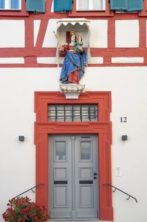 Figure of a saint above the front door of a residential building, Iphofen, Lower Franconia,