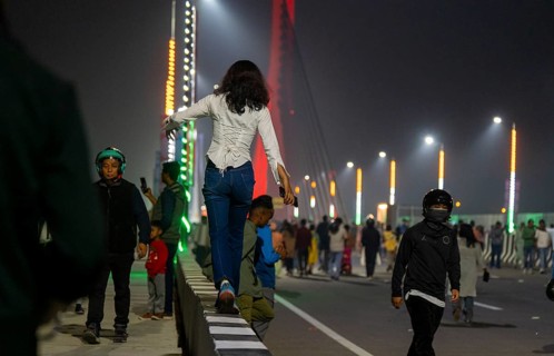 People gather on the newly inaugurated Kumar Bhaskar Varma Setu, a six-lane cable styled bridge