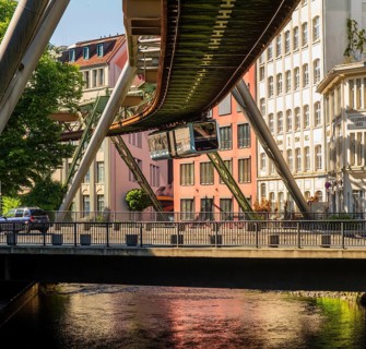 A suspension railway above a road with cars near the Kluse stop, Wuppertal, Germany