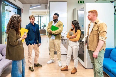 Business colleagues exchanging ideas during a casual meeting in a contemporary workspace, fostering