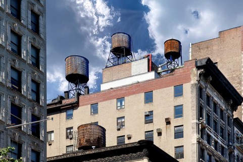 Wooden water storage tanks on the roof of a high-rise building, New York City, USA
