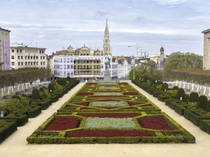 Geometric garden at Mont des Arts with a view of the statue of Albert I and the town hall tower in
