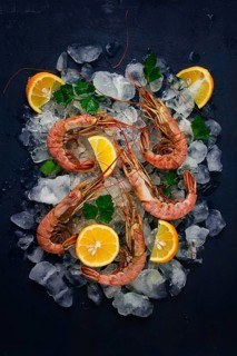 Tiger prawns, boiled and frozen, on ice, top view, close-up, no people