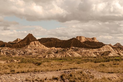 Eroded mountains and dry vegetation are creating an otherworldly landscape in the bardenas reales