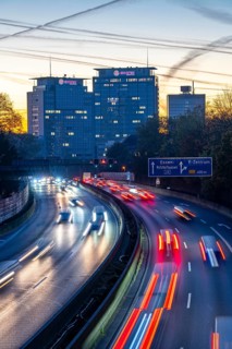 Evening traffic, partly with traffic jams, slow-moving traffic on the A40 motorway, Essen skyline,