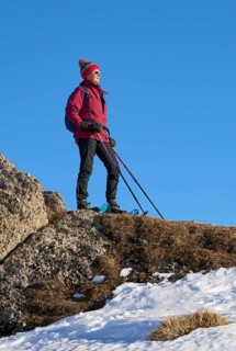 Nice and active senior woman snowshoeing in in the Allgau alps above Immenstadt, Bavaria, Germany