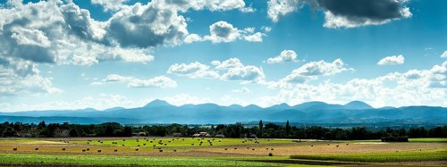 View of the Chain of Volcanoes and Limagne plain under a vibrant sky in Puy-de-Dôme,