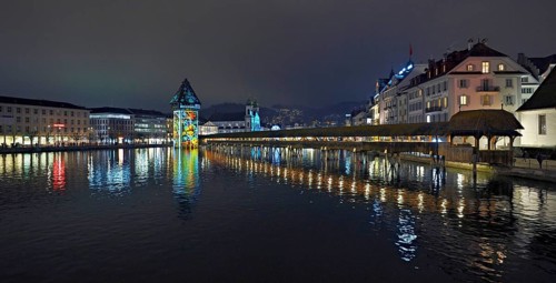 Wassertum with light installation, Chapel Bridge on the right, Jesuit Church on the Reuss at dusk