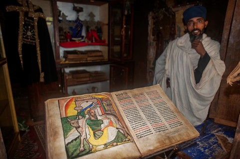 Old manuscript and orthodox monk in a monastery, Lake Tana, Ethiopia