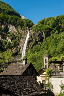 Picturesque mountain village with traditional old stone houses and waterfall, Foroglio, Bavona