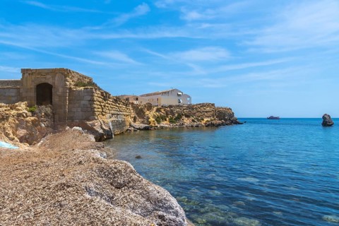 Tabarca island showcasing its historic coastal fortifications, traditional buildings, clean blue