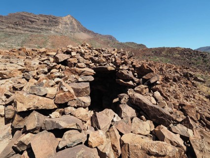 Large burial mound with an opening in a rocky mountain landscape, necropolis, Arteara necropolis,