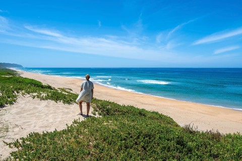Young tourist on sandy, ocean and sandy beach, Kleinkrantz Beach, Wilderness, South Africa