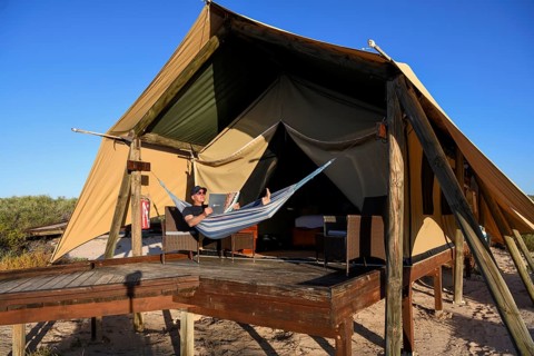 Tourist in a hammock, luxury camp Sal Salis, Cape Range National Park, Ningaloo Reef, near Exmouth,